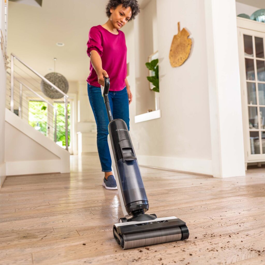Tineco vacuum cleaning dirt off a floor