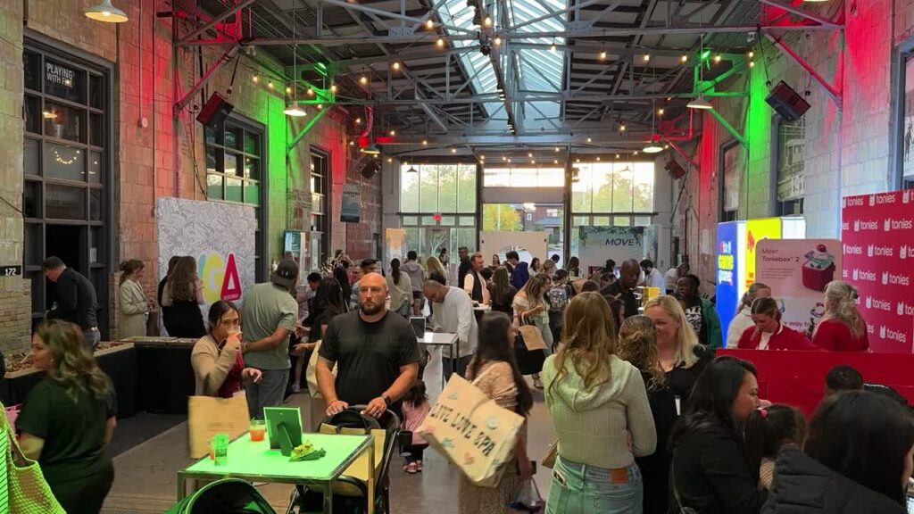 Guests visit exhibitor booths at Let's Play Holiday 2025