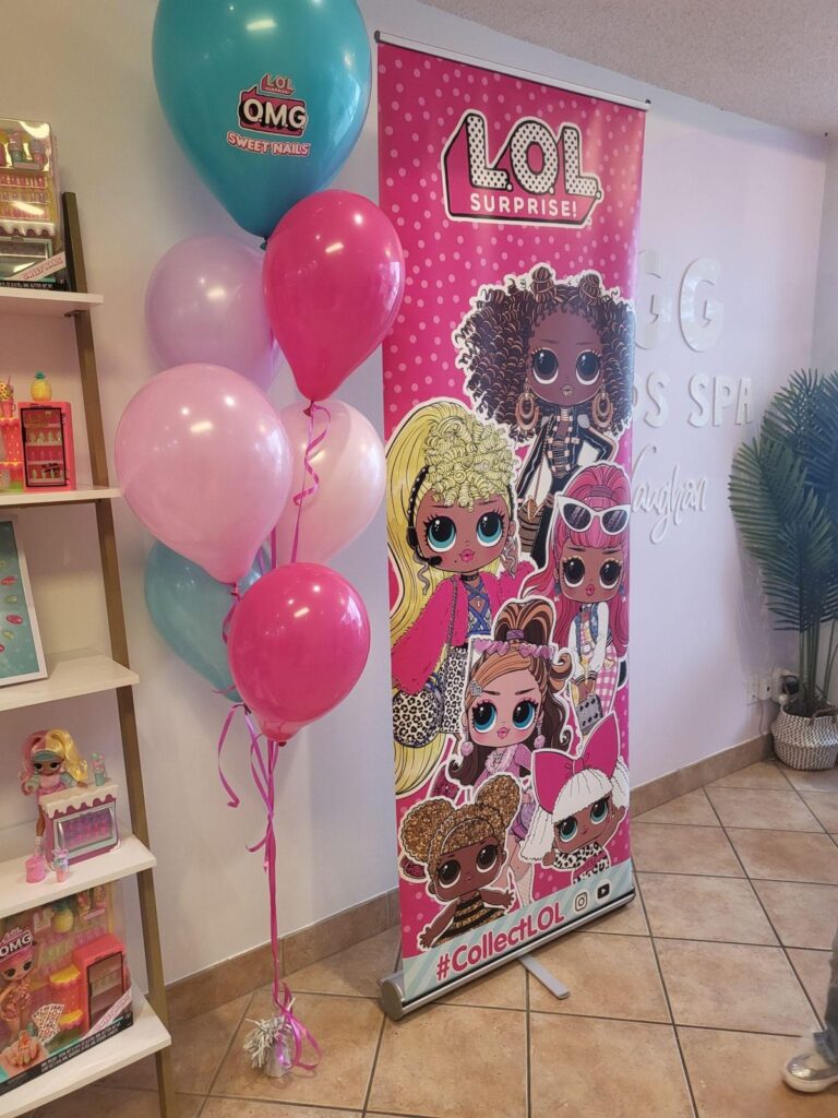 L.O.L. Surprise! banner and balloons at the O.M.G. Sweet Nails kids spa event